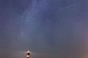 A meteor during the Perseid meteor shower seen over Happisburgh lighthouse, Norfolk, taken in August 2021.