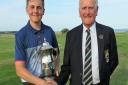Conal Downing receives the F W Mackenzie Cup from Suffolk Golf Union president Colin Firmin after winning the Suffolk Junior Championship. Picture: TONY GARNETT