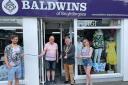 Chairman of Tendring District Council Gary Scott cuts the ribbon at Baldwins Brightlingsea, with Kevin Baldwin, second from left