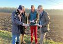 James Cartlidge, right, studying plans to put new pylons across south Suffolk with local residents.