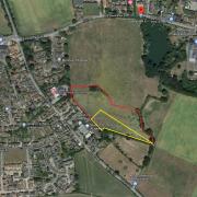 Land south of Old Stowmarket Road in Woolpit where 40 homes will be built. The red line shows the development site with the yellow section the proposed school extension area.