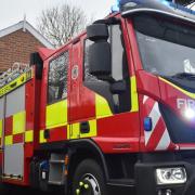Fire crews have rescued two people from a vehicle after a crash involving two vehicles