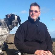 Roger Smith, 69, pictured with one of his dogs Ben on a walking holiday in the Lake District.