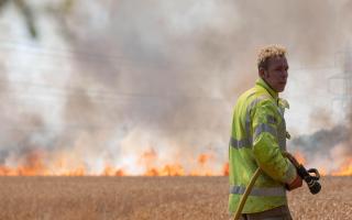 Firefighters on the scene of a standing crop fire in Campsea Ashe.